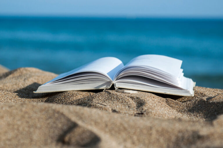 Book on a sandy beach